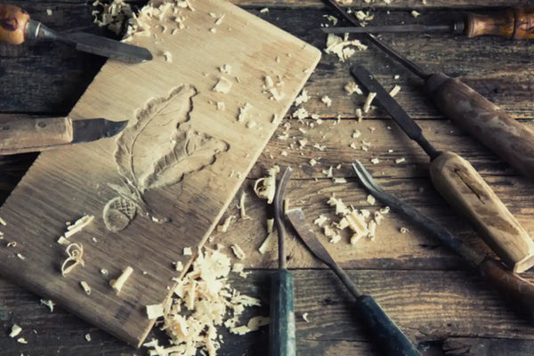 Carving leaves on a wooden board