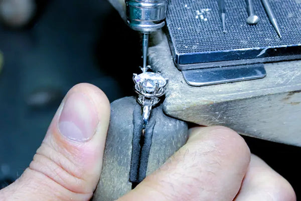 Engraving jewelry with a sharp tip