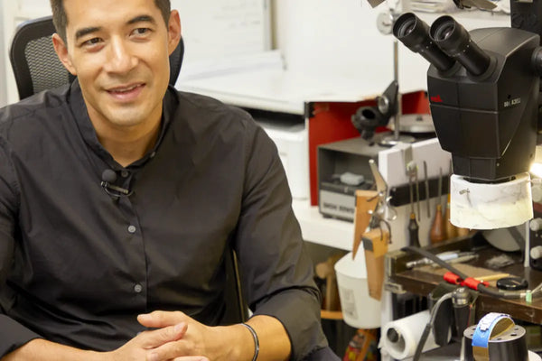 Master engraver poses with his stereo microscope