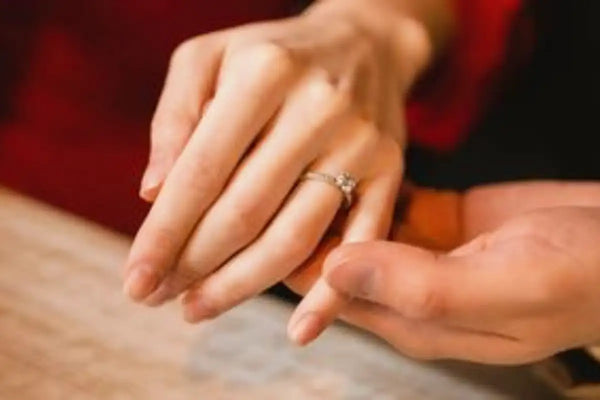 Women with fine rings on their fingers.