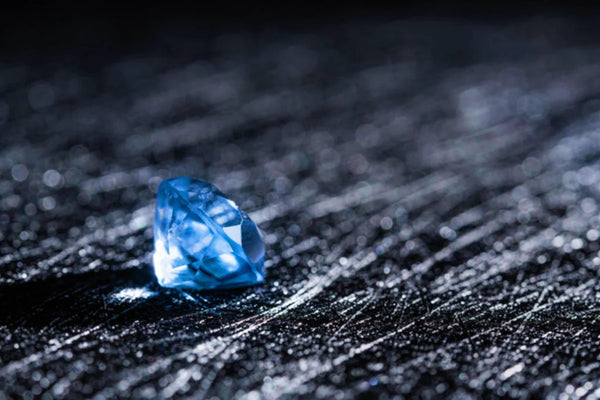blue natural diamond stone black background jeweler work
