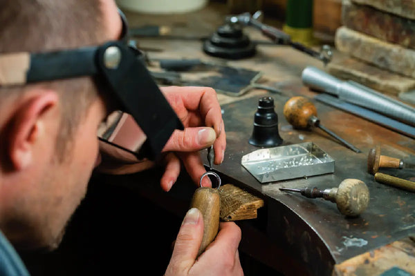 stock-photo-man-putting-diamond-on-ring
